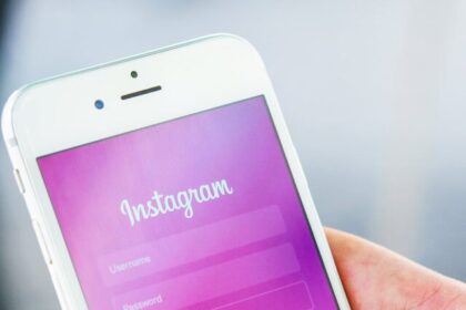 person holding phone while logging in on instagram application